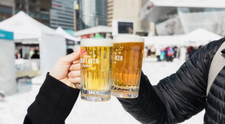 Two people toasting craft beer at Steam Whistle Winter Craft Beer Festiv